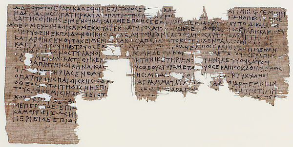 Stück Papyrus mit griechischen Schriftzeichen mit großen Löchern