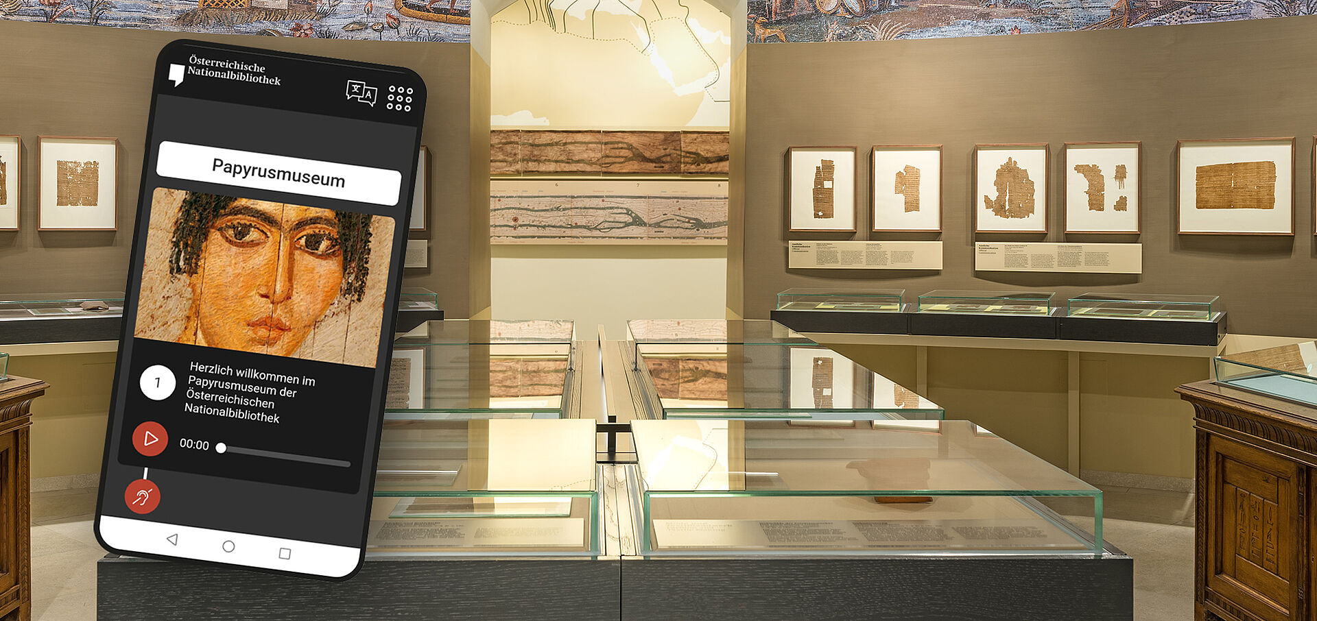 Ansicht des Papyrusmuseums. Links im Bild ein Handy mit einem Ausschnitt des Audioguides. Bild von schwarzgelockter Frau.