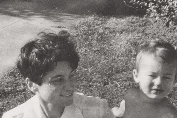 photo of a woman with short, black hair and a small child, outside