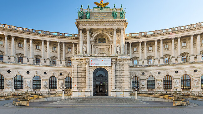 Magnificent building with a golden eagle on the roof.